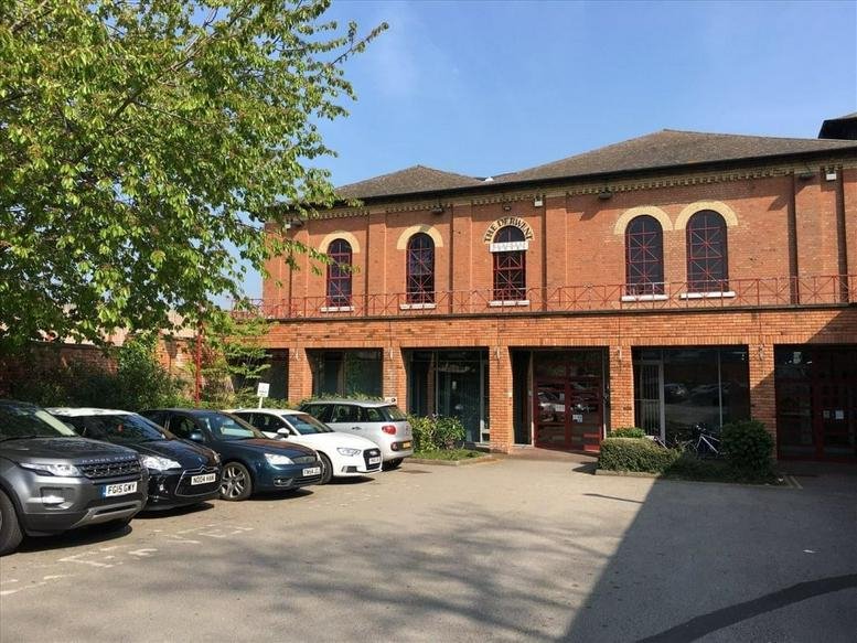 Exterior view of the red brick Derwent Business Centre, Clarke Street, Derby, Derbyshire with parked cars.