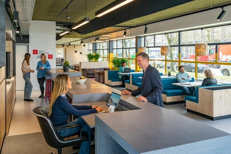 Spacious communal lounge at Disketteweg 14 with modern seating and high ceilings.