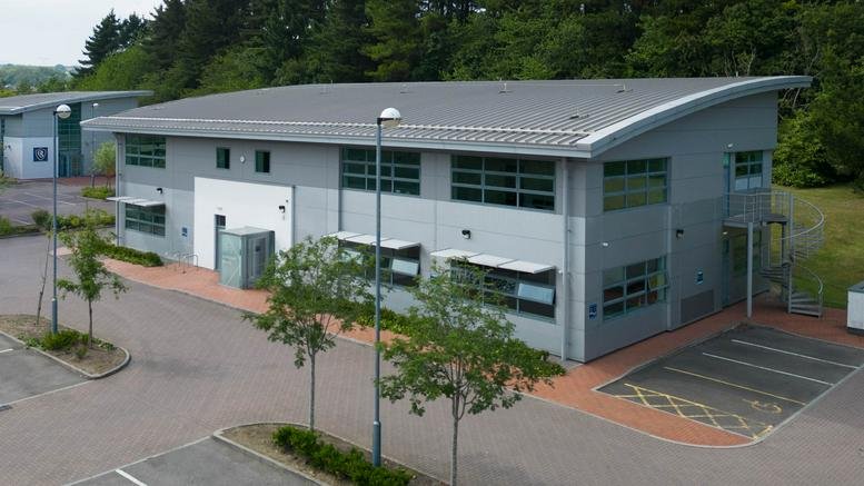 Exterior view of the grey industrial-style office building at Dunleavy Drive, Cardiff.
