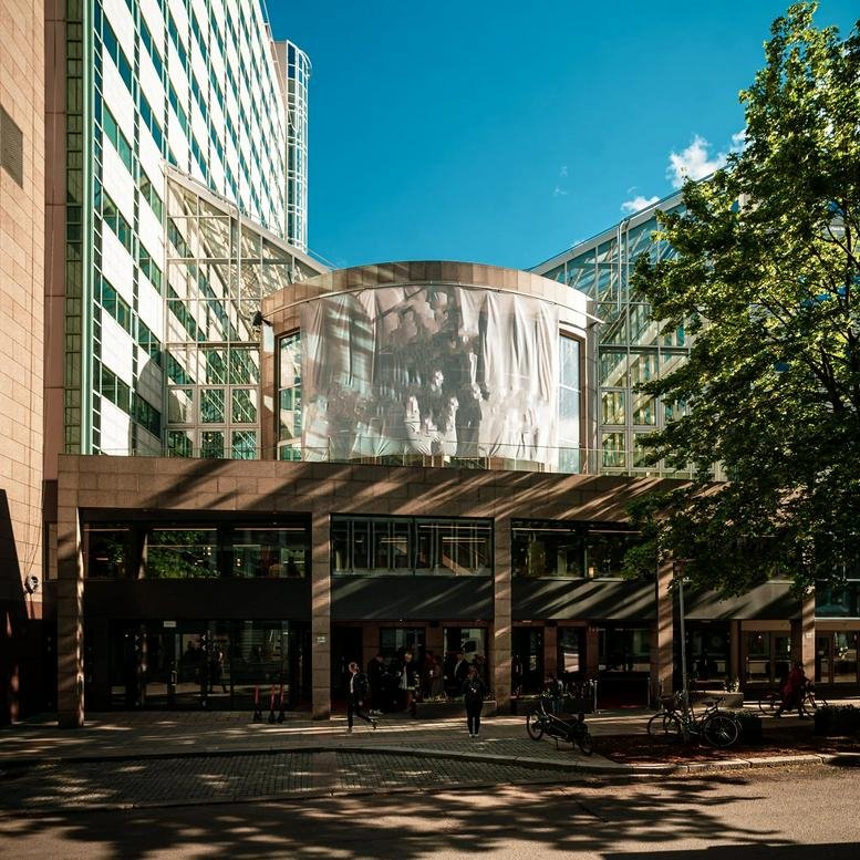 Exterior view of the modern glass and stone building at Edvard Storms Gate 2, Oslo.