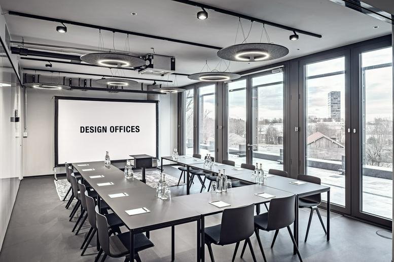 Spacious boardroom at Einsteinstraße 174 with a U-shaped table and presentation screen.
