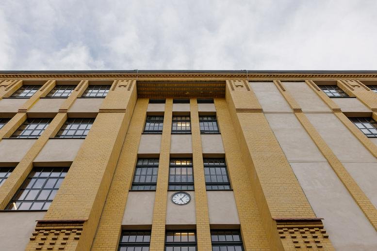 Low-angle exterior view of the historic brick and stone facade of Eiswerk at Köpenicker Strasse 40, 41.