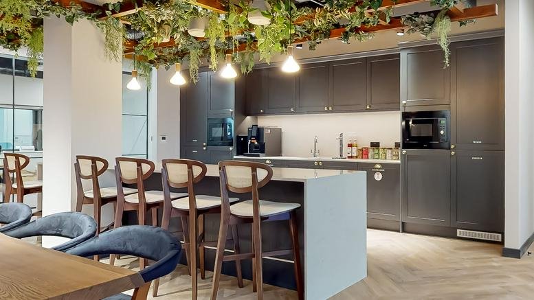 Elder House, Milton Keynes modern kitchen and breakfast bar area with overhead greenery and pendant lighting.