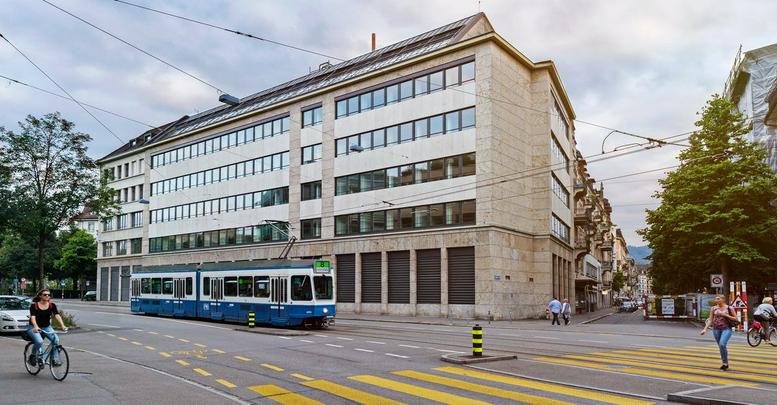 Exterior street view of the classic stone facade building at Ernst-Nobs-Platz 1, Zurich.