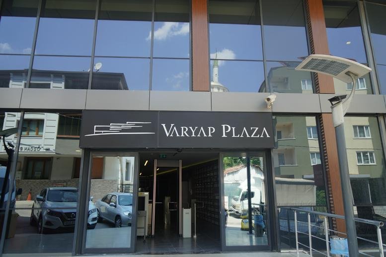 Exterior view of the modern glass facade and entrance at Varyap Plaza.