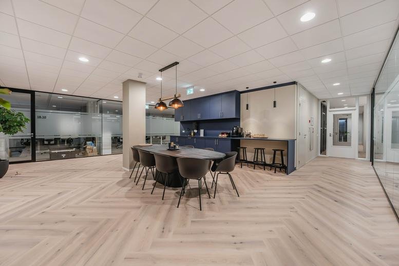 Spacious communal kitchen and dining area with herringbone floors at Euclideslaan 265, Utrecht.
