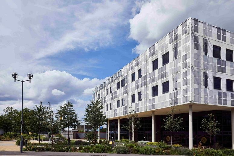 Exterior view of the modern grid-patterned facade of Faraday Wharf, Holt Street, Birmingham.