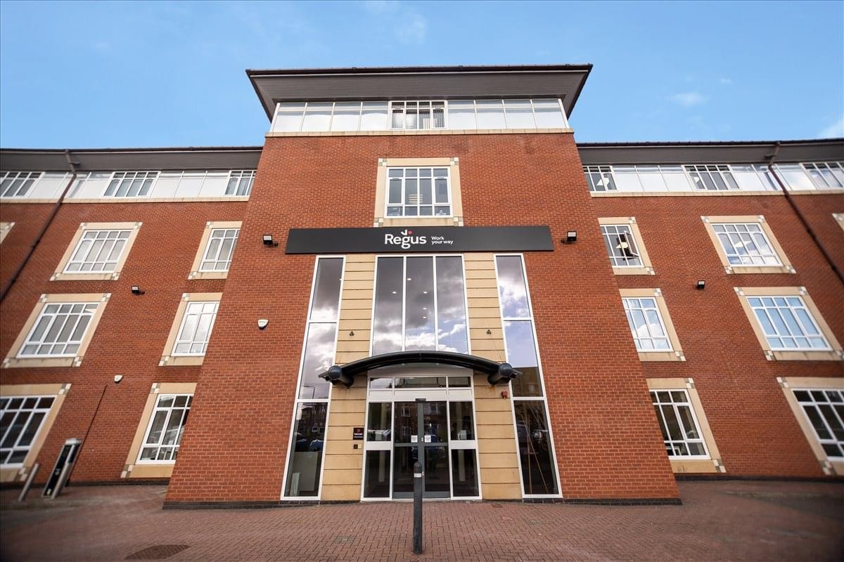 Red brick exterior of Fast Track House, Thornaby, Stockton-on-Tees with a central glass entrance.