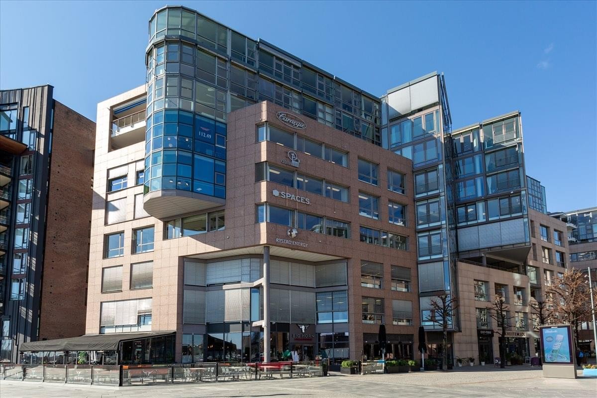 Exterior view of the modern brick and glass building at Fjordalleen 16, Aker Brygge, Oslo.