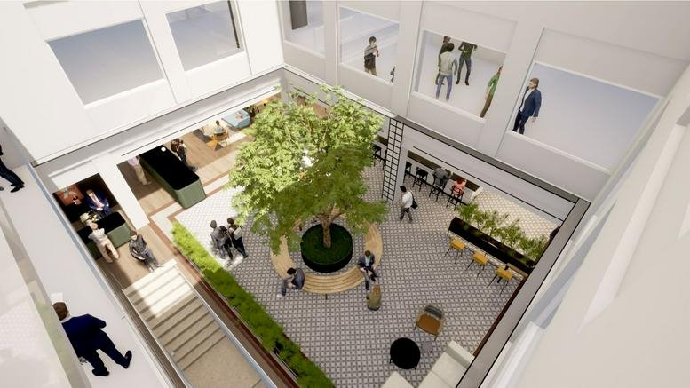 Aerial view of courtyard with tree and seating.