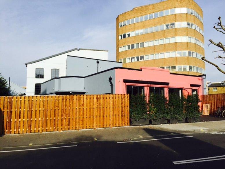 Exterior view of the colorful pink and grey buildings at Fulham Green.