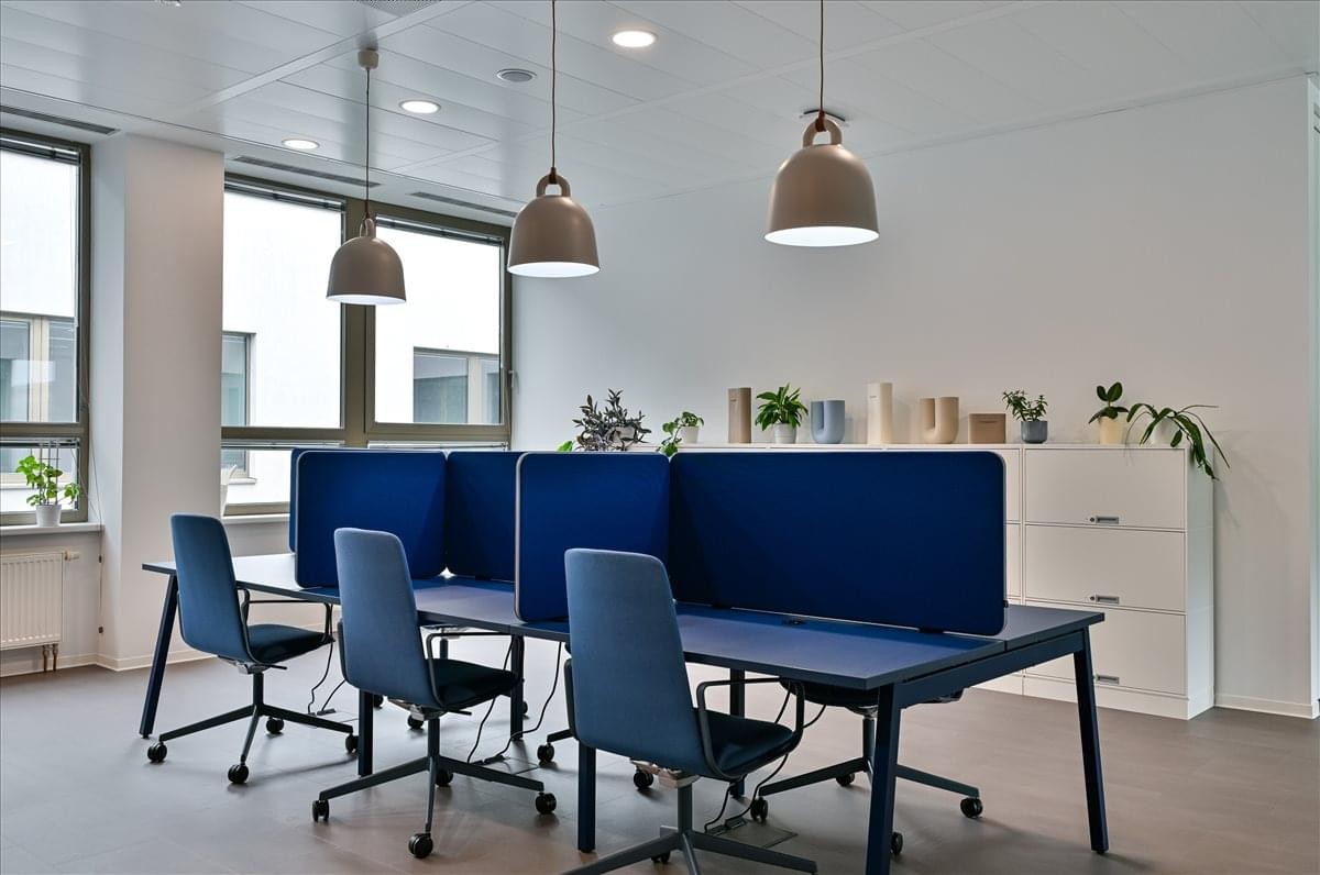 Coworking space with blue privacy screens and modern pendant lighting at Galvaniho 15/B.