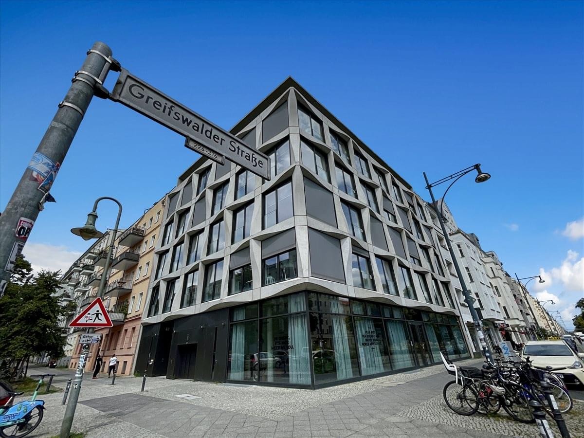 Exterior view of the contemporary corner building facade at Greifswalder Straße 226.