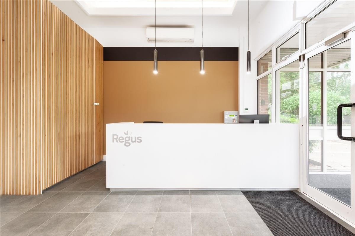 Bright reception desk at Gibson House, Ermine Business Park, Huntingdon featuring wood-slat walls.