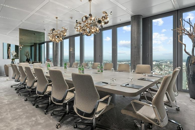 Large boardroom with long table and floor-to-ceiling windows overlooking the city.