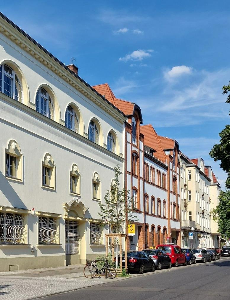Exterior facade of the historic Postwerk building with unique arched windows.