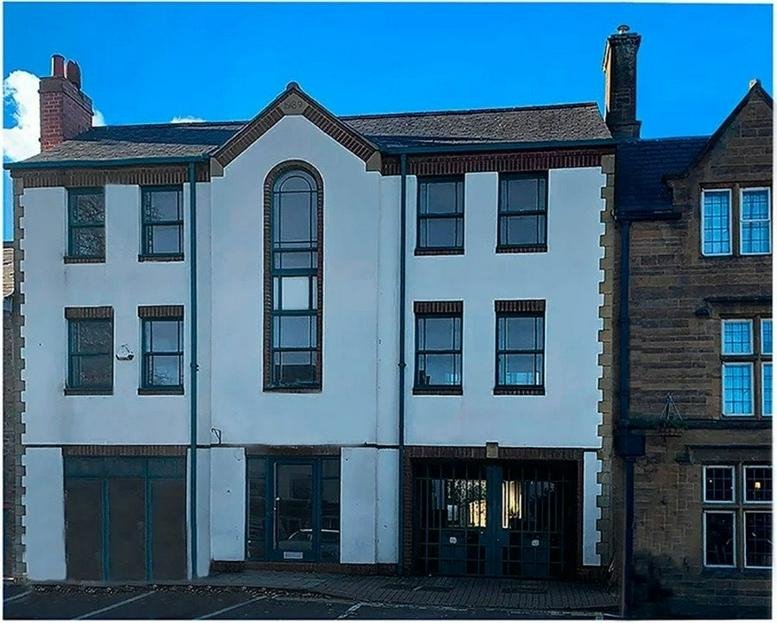 Exterior view of the white and brick facade of Guardian House, 7 North Bar Street, Banbury.