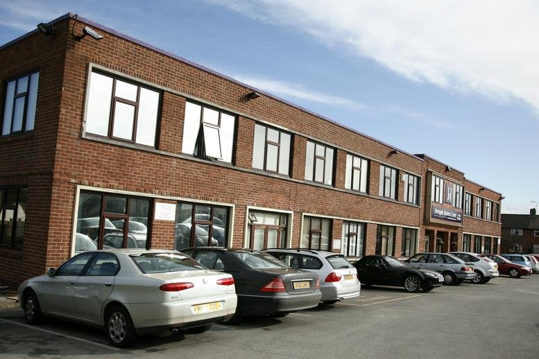 Exterior view of the brick facade at Hammerain House, Hookstone Avenue with on-site parking.