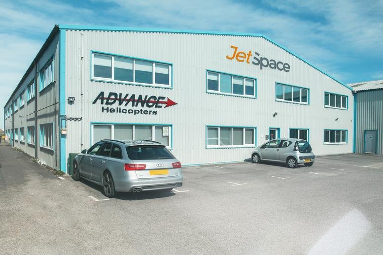 Exterior view of the light gray industrial facade at Hangar 4, Cecil Pashley Way, Shoreham-By-Sea.