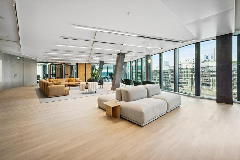 Spacious open-plan lounge at Hardstrasse 201 with modular seating and floor-to-ceiling windows.