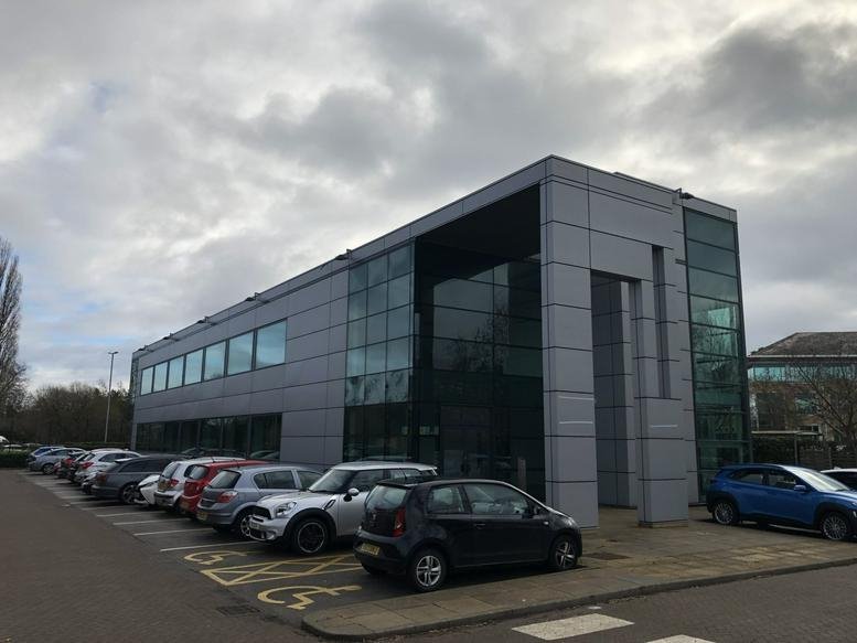 Exterior view of the modern glass and silver facade at Highfield House, Cheadle Royal Business Park.