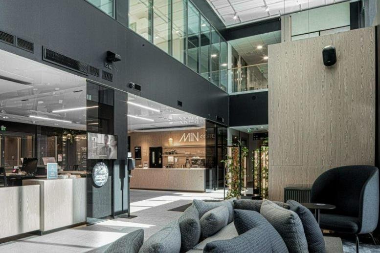 Spacious modern lobby at Technopolis Ruoholahti 1 featuring a reception desk and high ceilings.