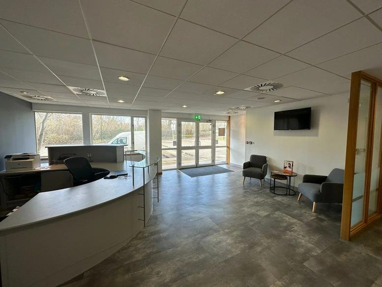 Spacious reception area at Hill of Rubislaw, Royfold House, Aberdeen with curved front desk and seating.