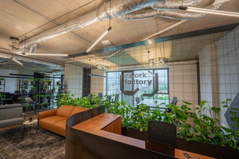 Spacious reception area with leather sofas, lush greenery, and modern lighting at 1 Atanas Dukov Str. floor 6.