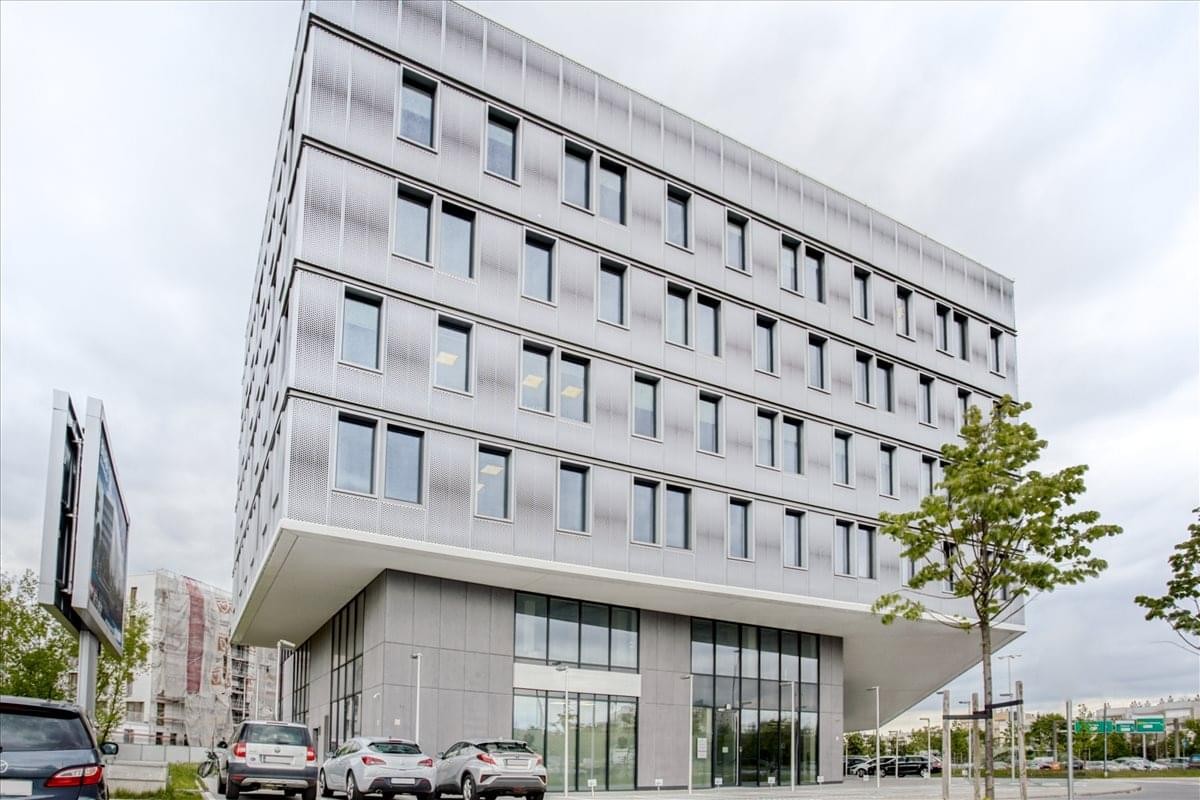 Exterior view of the modern, multi-story glass and grey facade at Idzikowskiego 16.