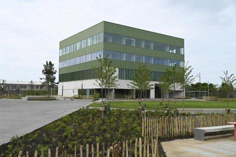 Exterior view of the modern green and white Innovation Quarter, Belgard Square North.