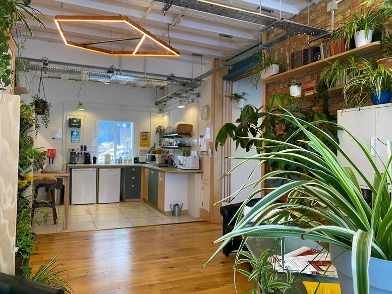 Communal break area at 14 Windermere Rd 2nd Floor, Islington, with plants and a geometric ceiling light.