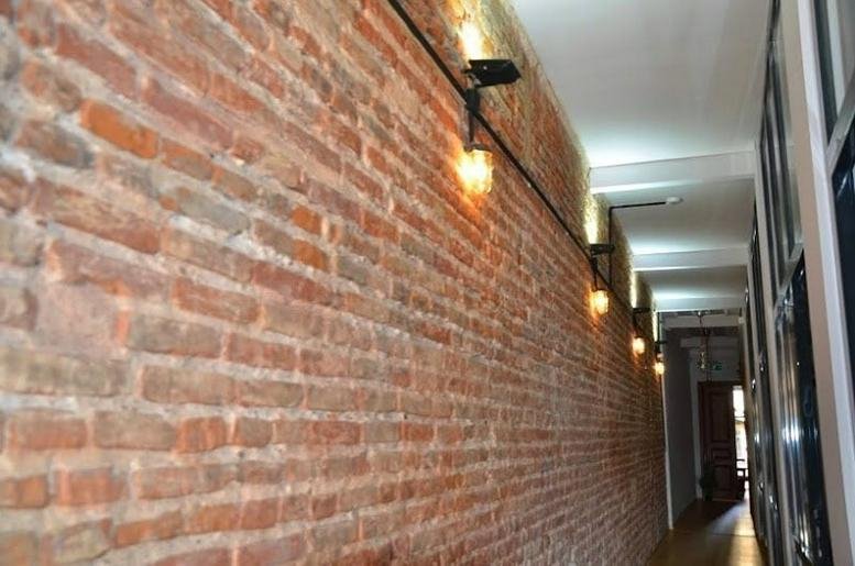 Exposed brick hallway with vintage-style warm lighting at Istiklal Cd. 189 Tomtom Mh. Beyoğlu, Istanbul.