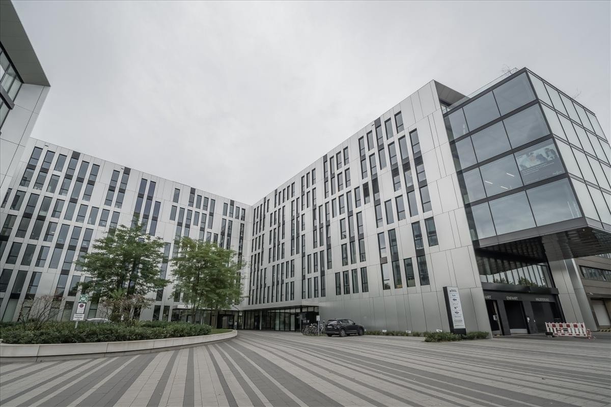 Exterior view of the modern glass-facade building at Johannstrasse 37.