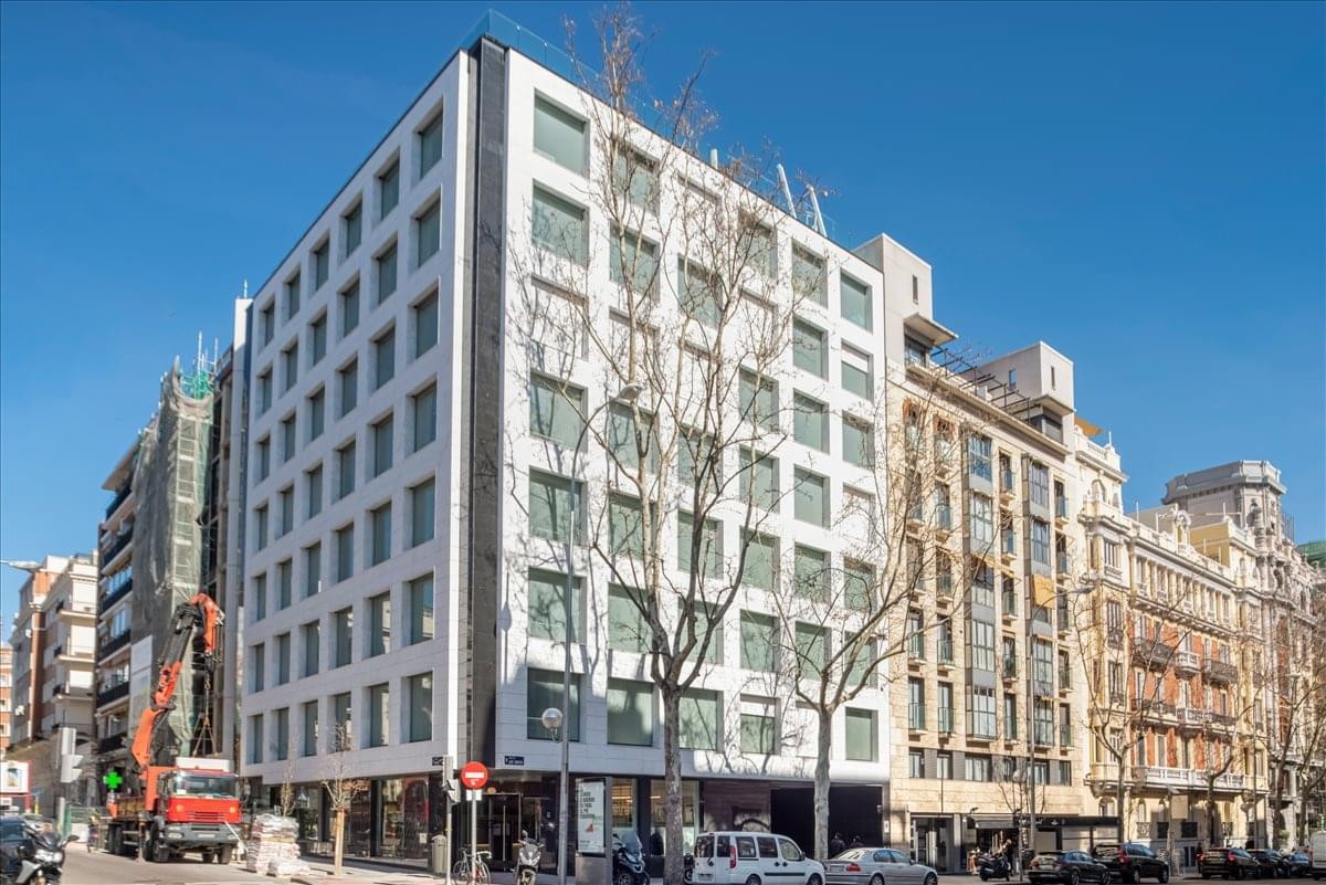 Exterior view of the white modern facade and classic architecture at Jose Abascal 41, Madrid.