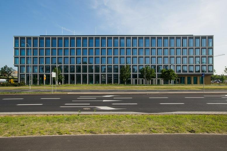 Exterior view of the modern glass-facade building at Jozefa Dziekonskiego 1 street.