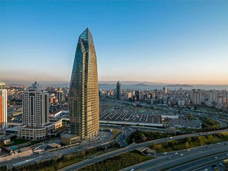 Exterior view of the glass-facade Allianz Tower standing tall against the city skyline.