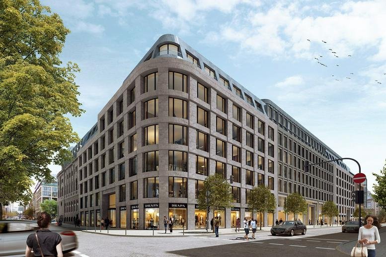 Exterior view of the stone-facade KÖ-Quartier building during the day.