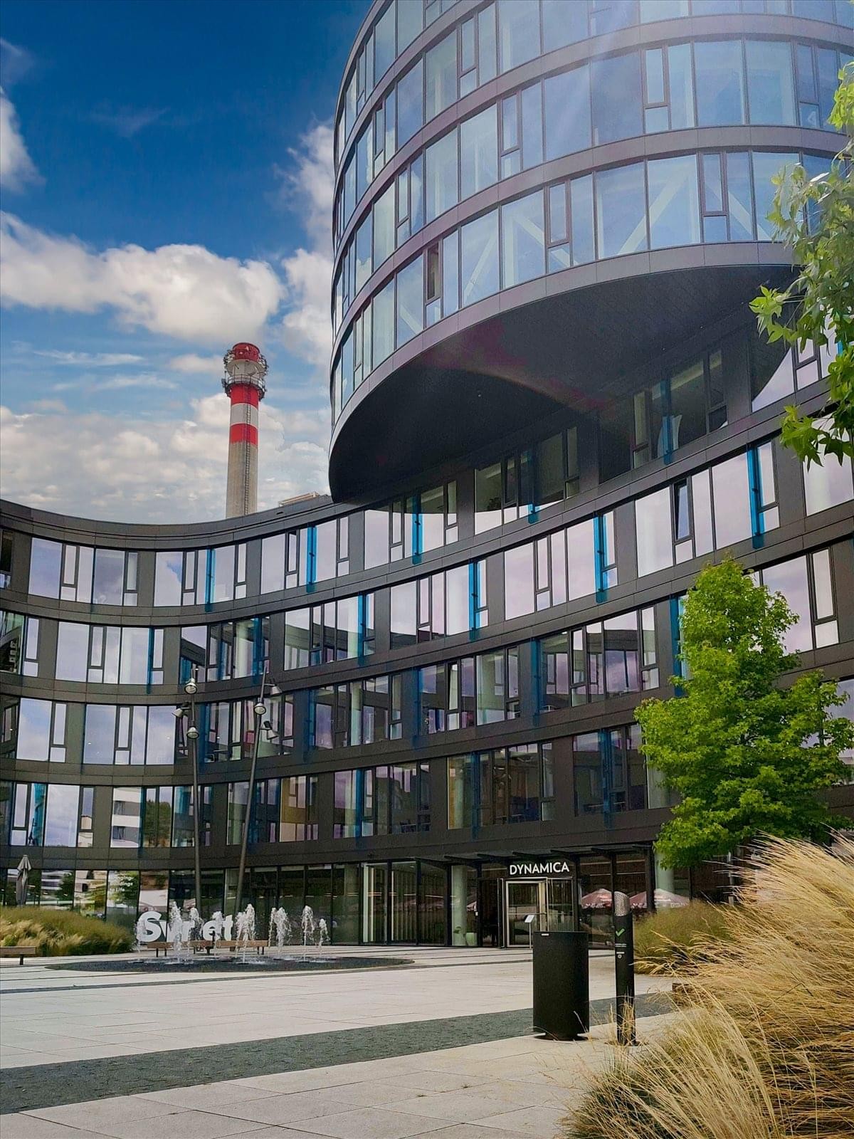 Exterior view of the curved glass facade of the Dynamica building at Kacírkova 982/4, Waltrovka.
