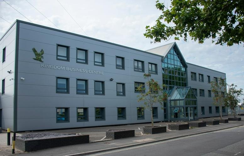 Exterior view of the modern Kingdom House, Brunel Road building with its glass entrance and grey facade.