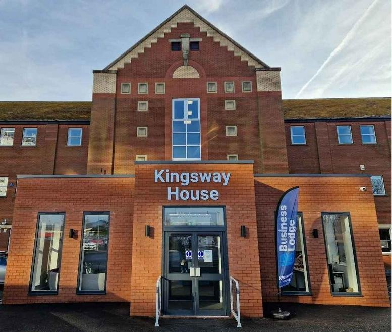 Exterior entrance of the brick-built Kingsway House with modern signage and glass doors.