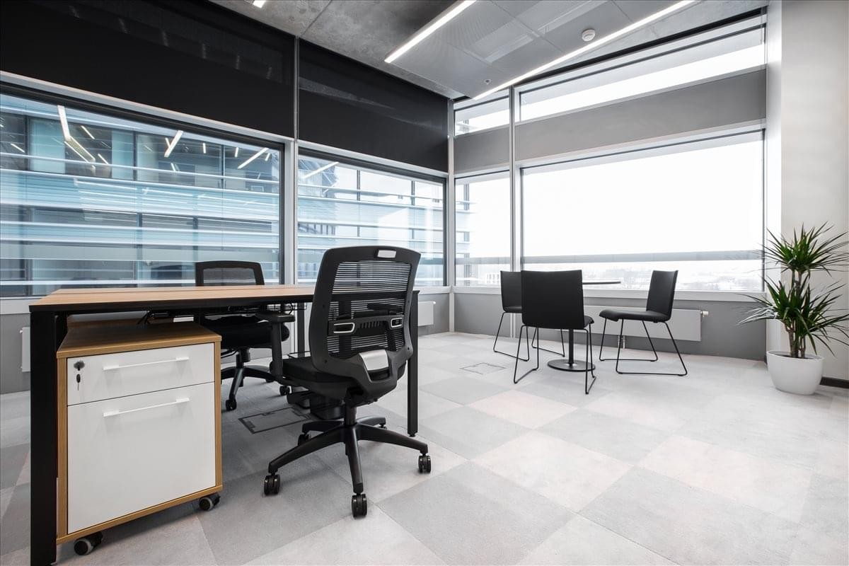 Spacious professional workspace with two desks and floor-to-ceiling windows at Konstitucijos av. 21A, Vilnius.