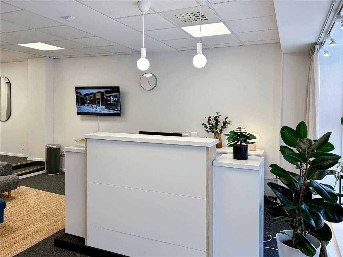 Bright, modern reception area at Kungsgatan 11, Ground, 1st and 2nd Floor, Uddevalla featuring white desks and plants.