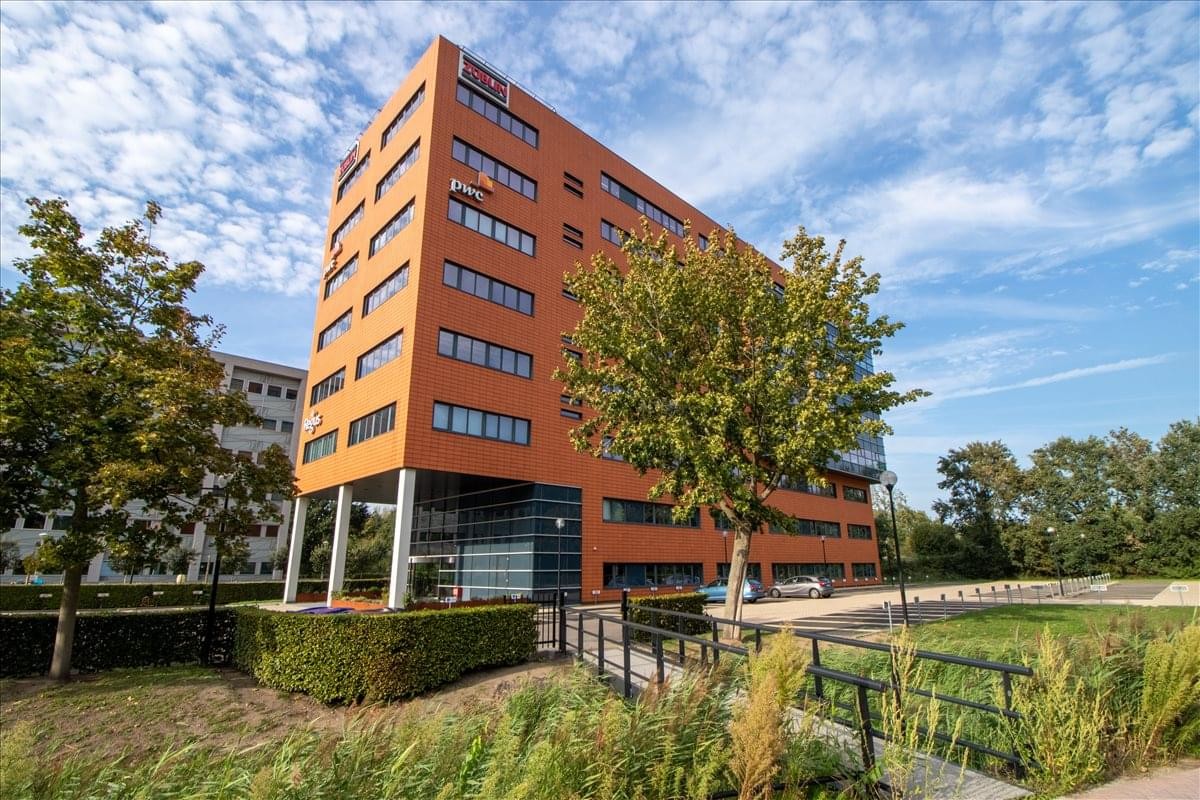 Exterior view of the orange brick facade at Lage Mosten 49-63, Breda.