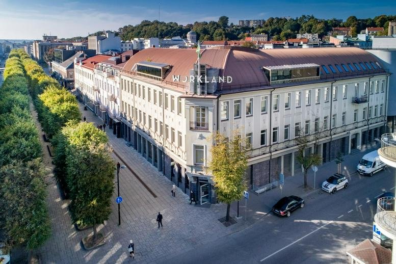 Exterior view of the historic white and red-roofed building at Laisves Avenue 82, Kaunas.