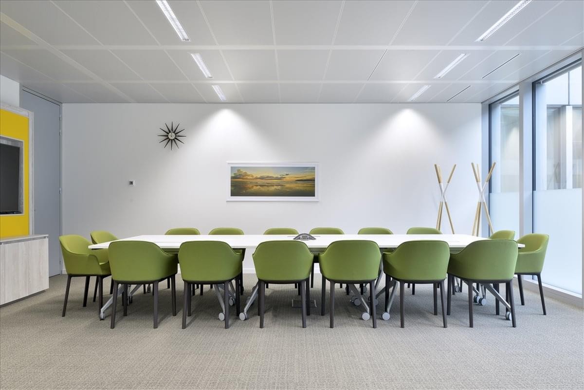 Spacious boardroom with green chairs and minimalist decor at Lars Hillesgate 19, Etasje 6.