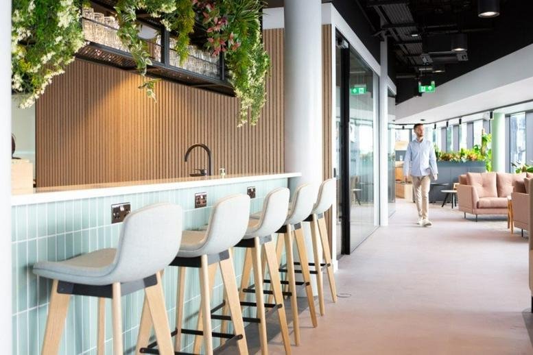 Spacious breakout area at Lighthouse, 1 King’s Cross Bridge with bar seating and hanging plants.