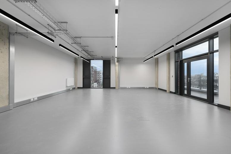 Spacious, bright interior office space at Lock Studios with large windows and white walls.
