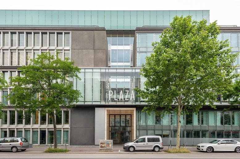 Modern exterior of Mainzer Landstraße 178-190 with glass facade and mature street trees.