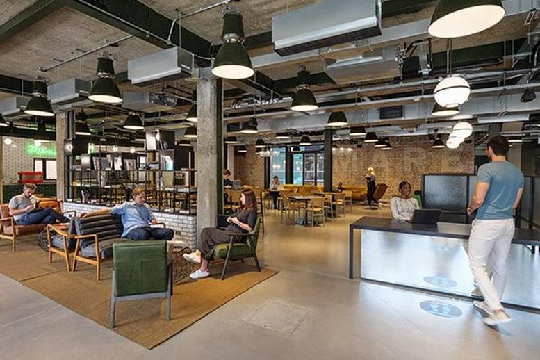 Spacious communal lounge and reception area at Mare Street Studios with industrial ceilings and modern furniture.