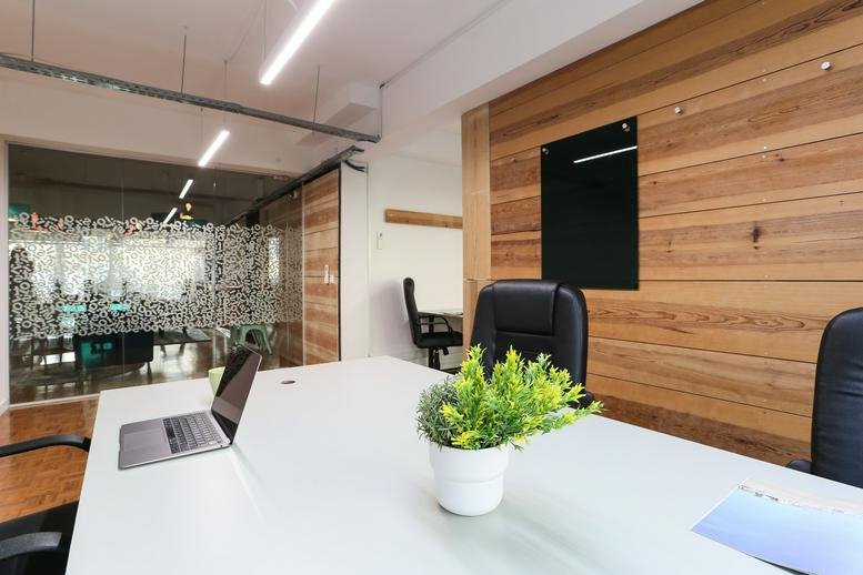 Meeting space at Marques, Rua do Conde Redondo, 145, Lisbon with wood panelled walls and laptop.